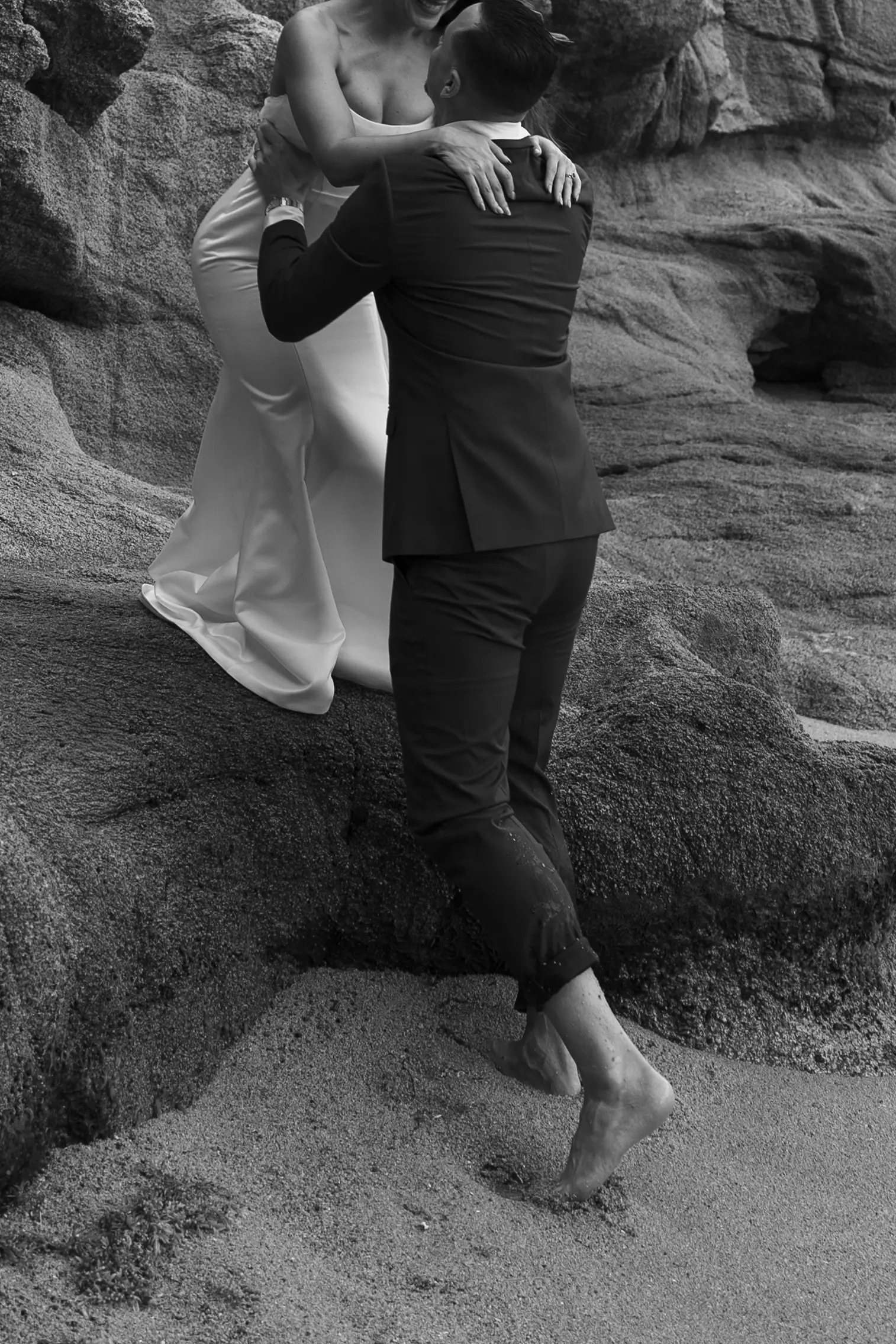 Bride and groom sharing a first look on a rocky coastline