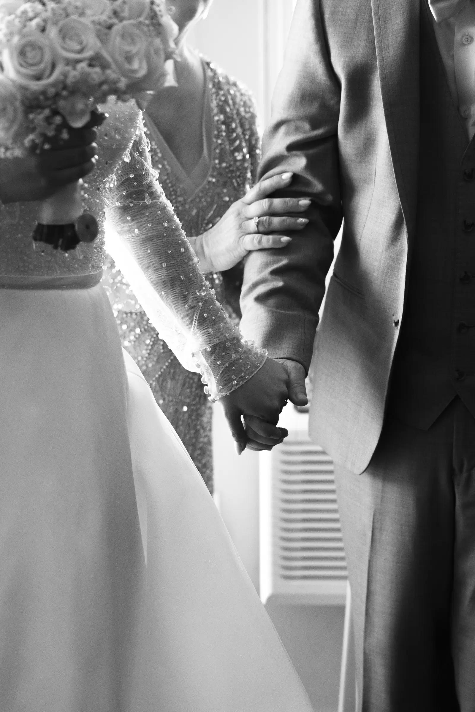 Close-up of the groom's boutonniere and jacket sleeve