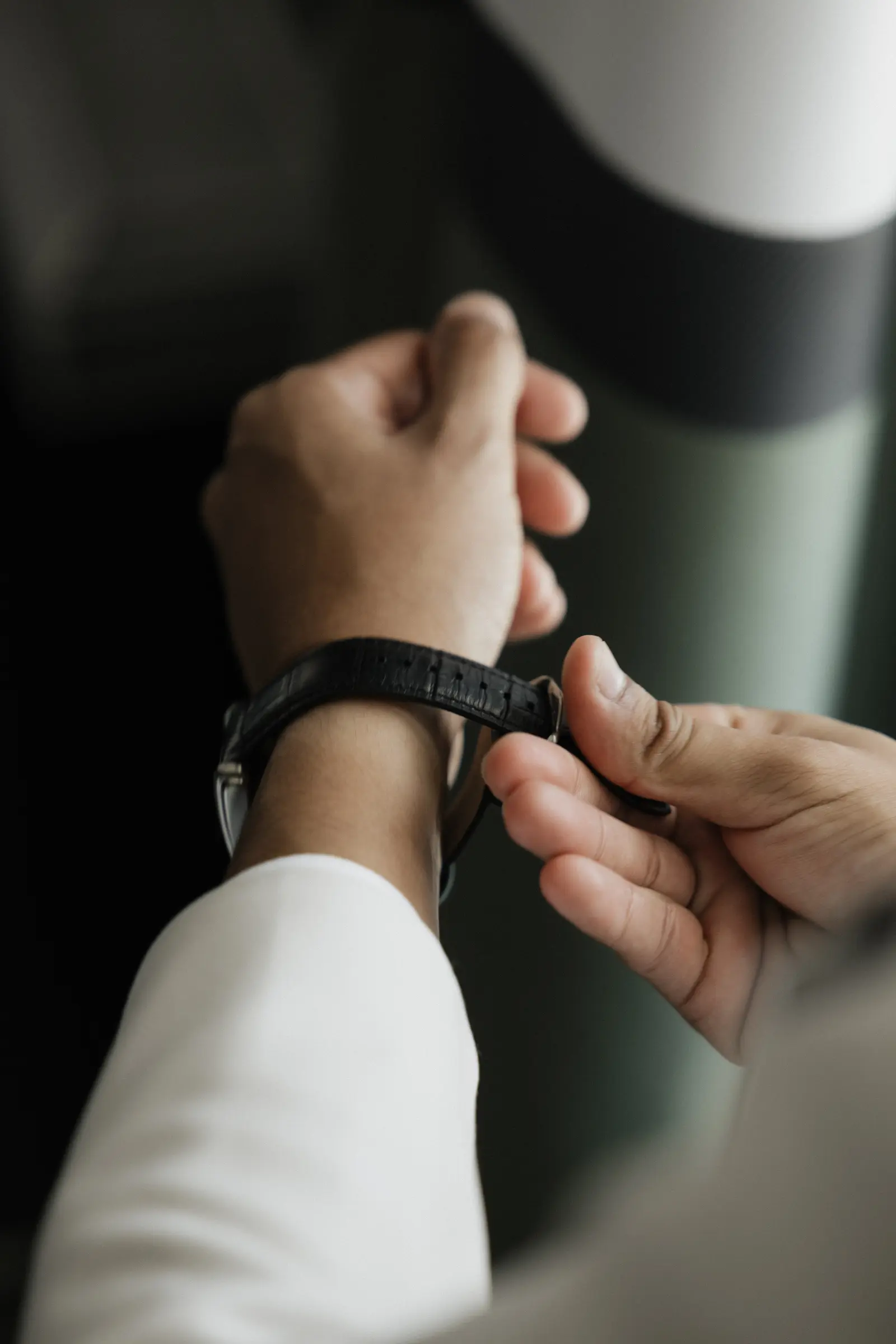 Close-up of the groom fastening his watch