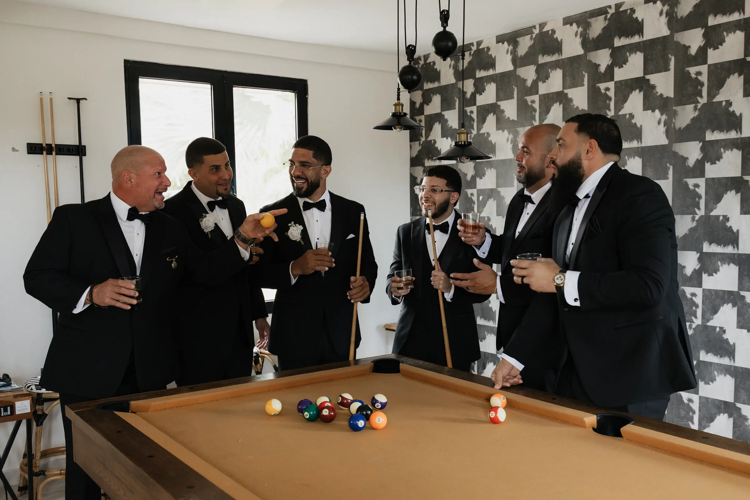 Groomsmen playing pool before the wedding