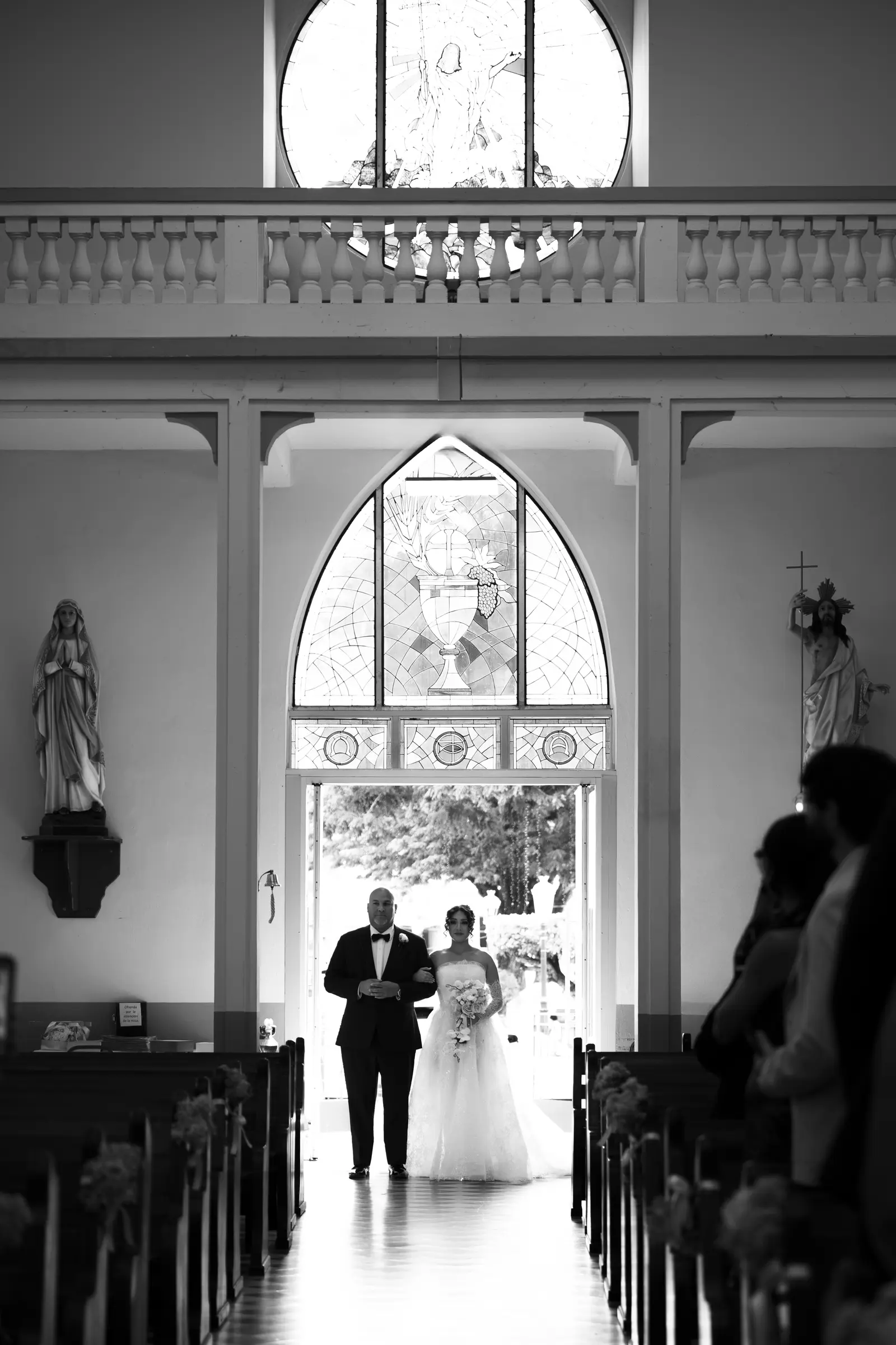 Wedding ceremony aisle viewed through an arched doorway