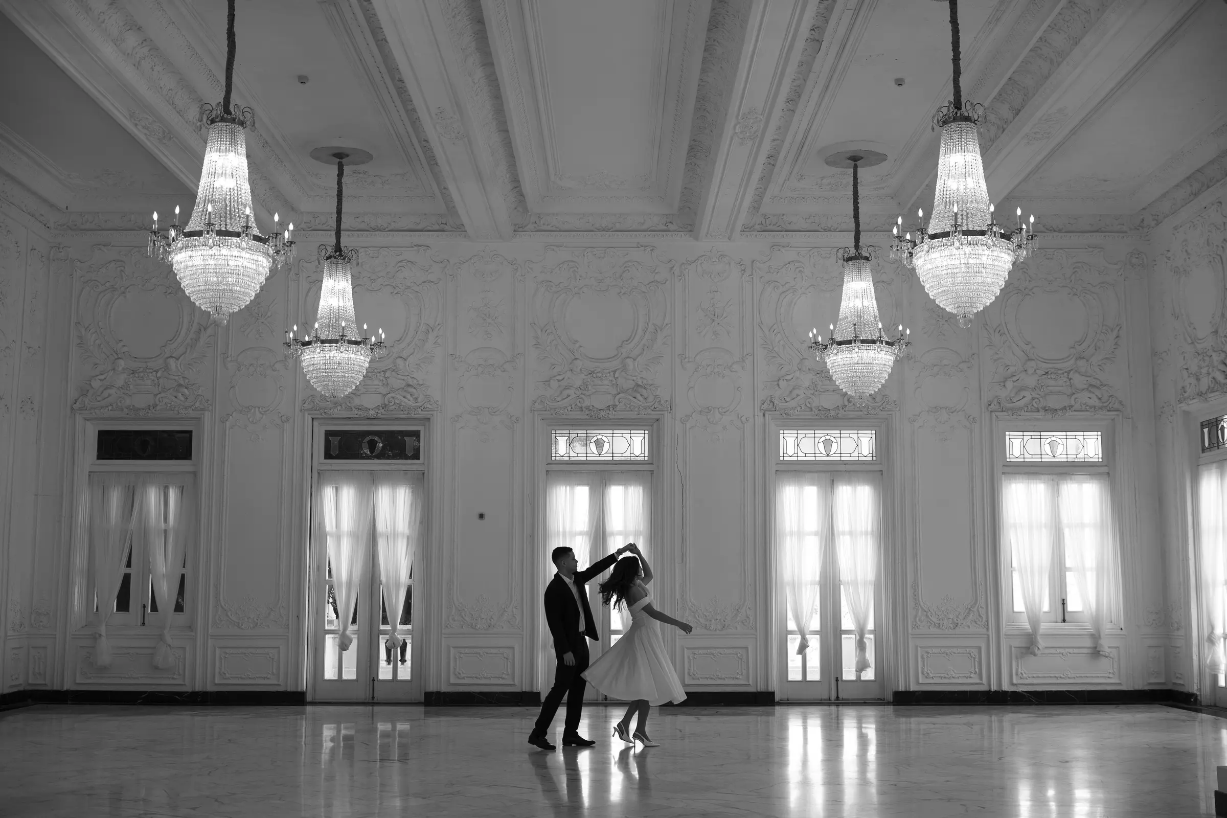Bride and groom's first dance inside a bright ballroom