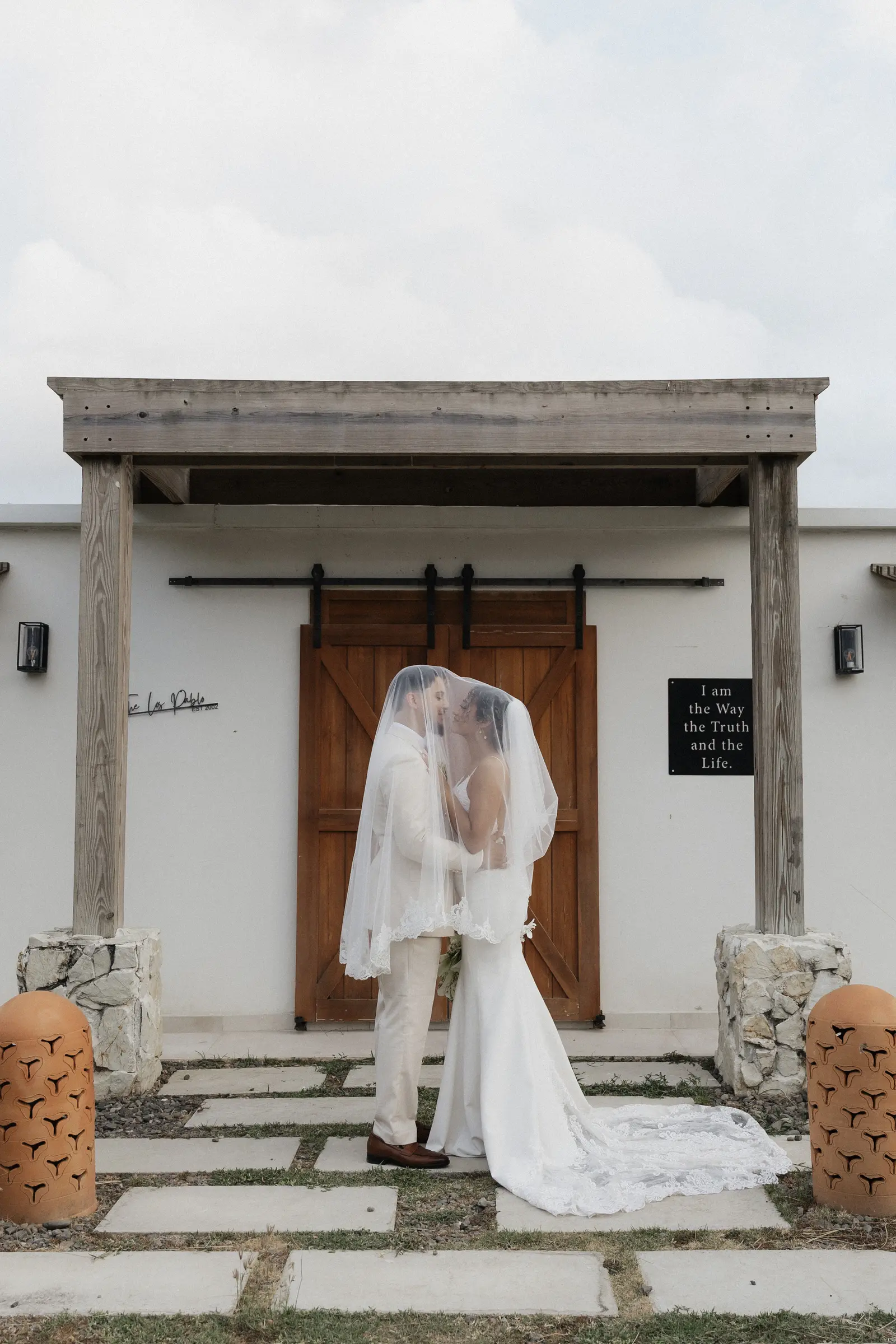 Wedding dress hanging in an archway entrance