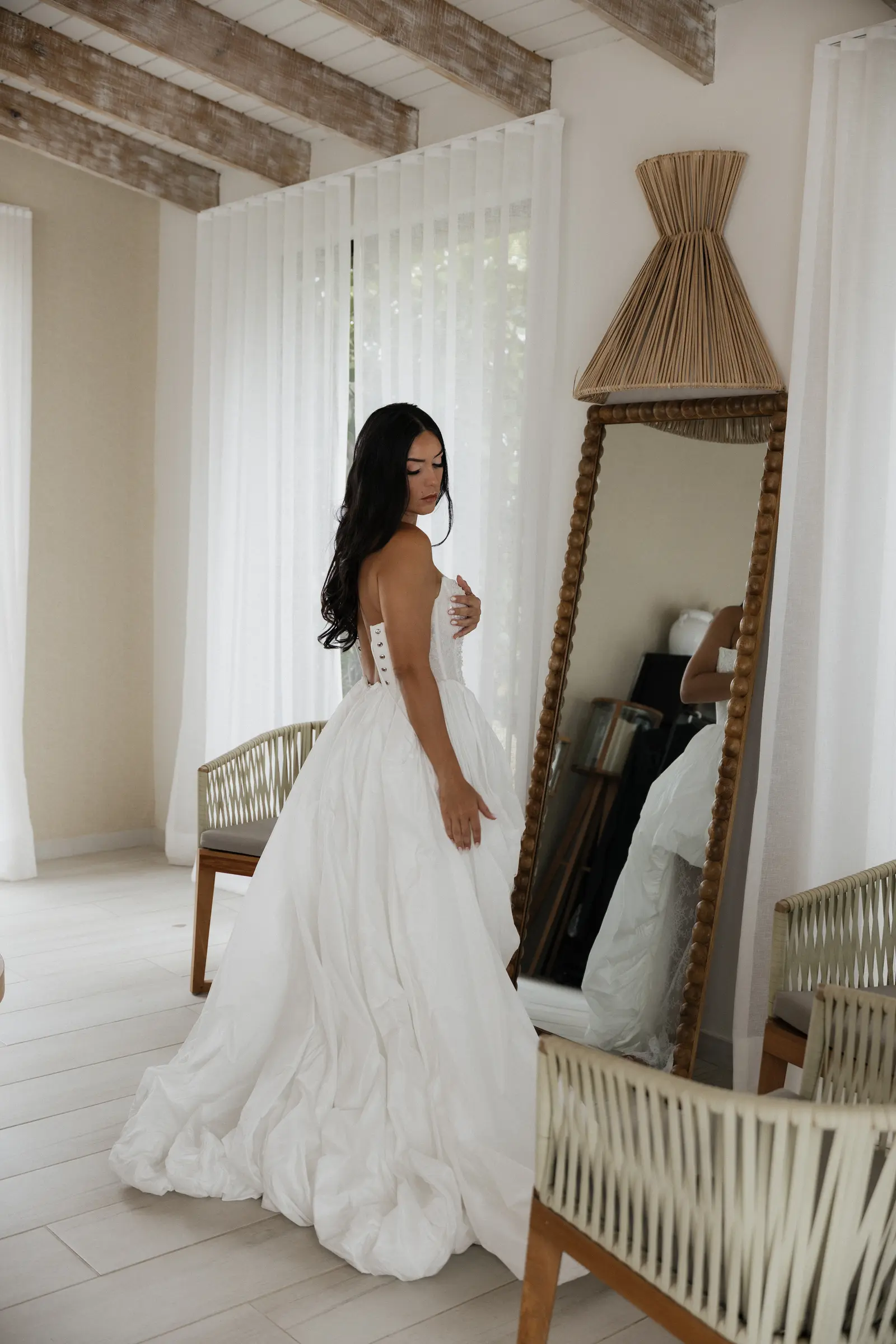 Bride looking in a mirror while getting ready