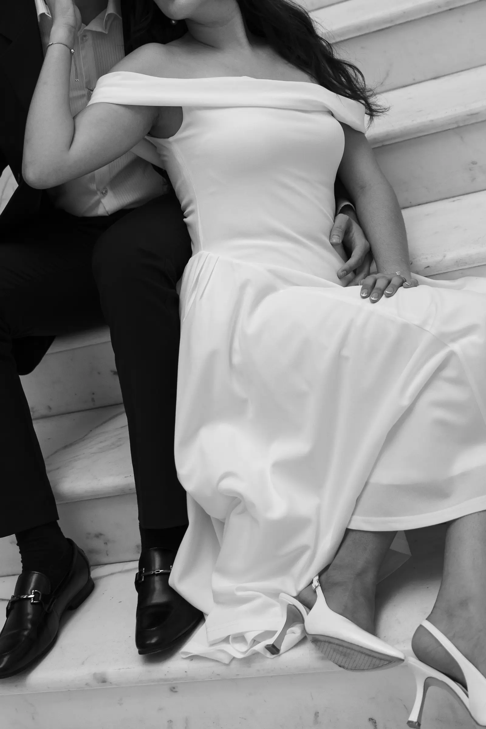 Bride walking down a staircase in her wedding dress