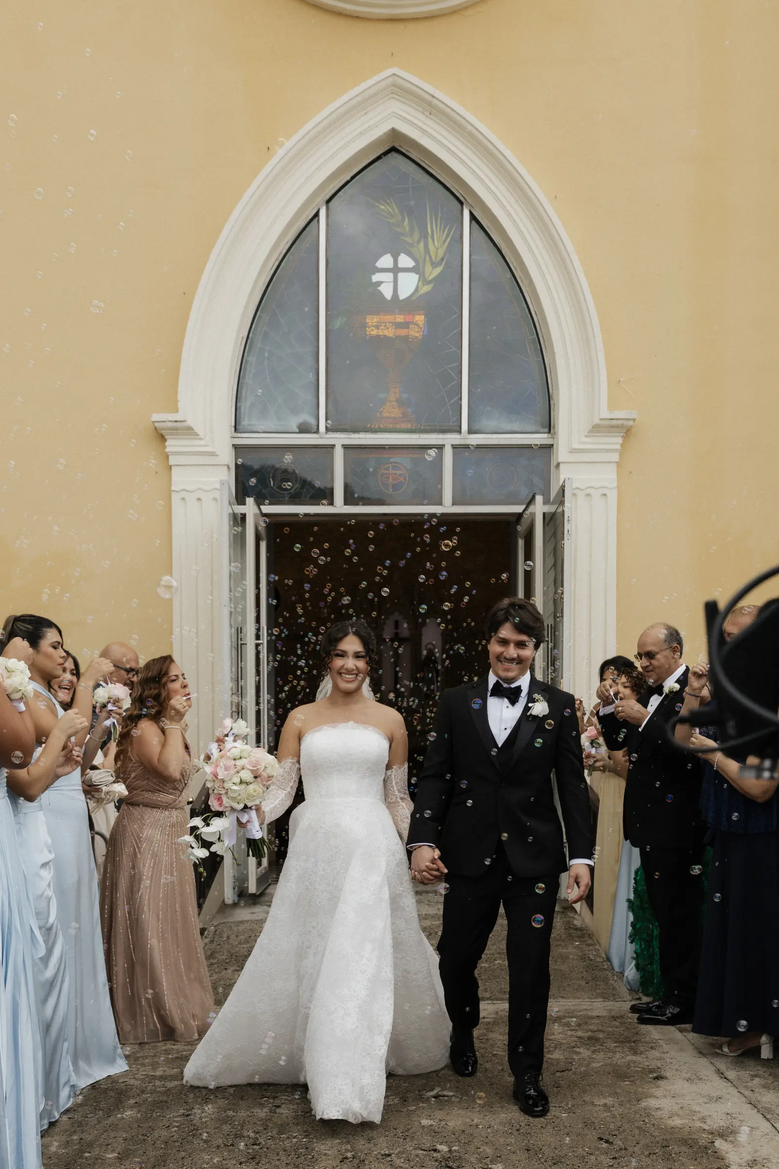 Bride and groom walking together after the ceremony outside a chapel
