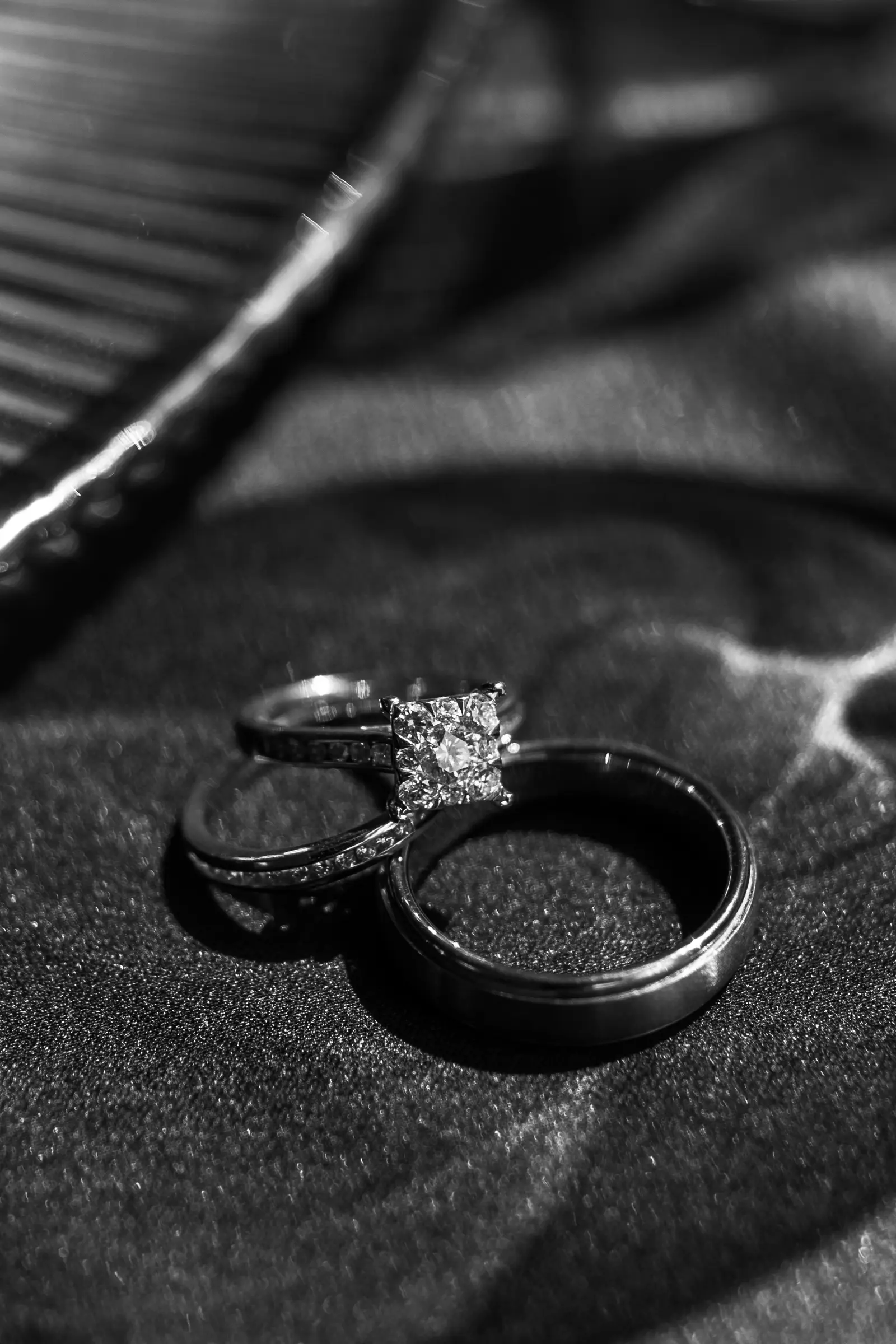 Close-up of wedding bands on a dark surface