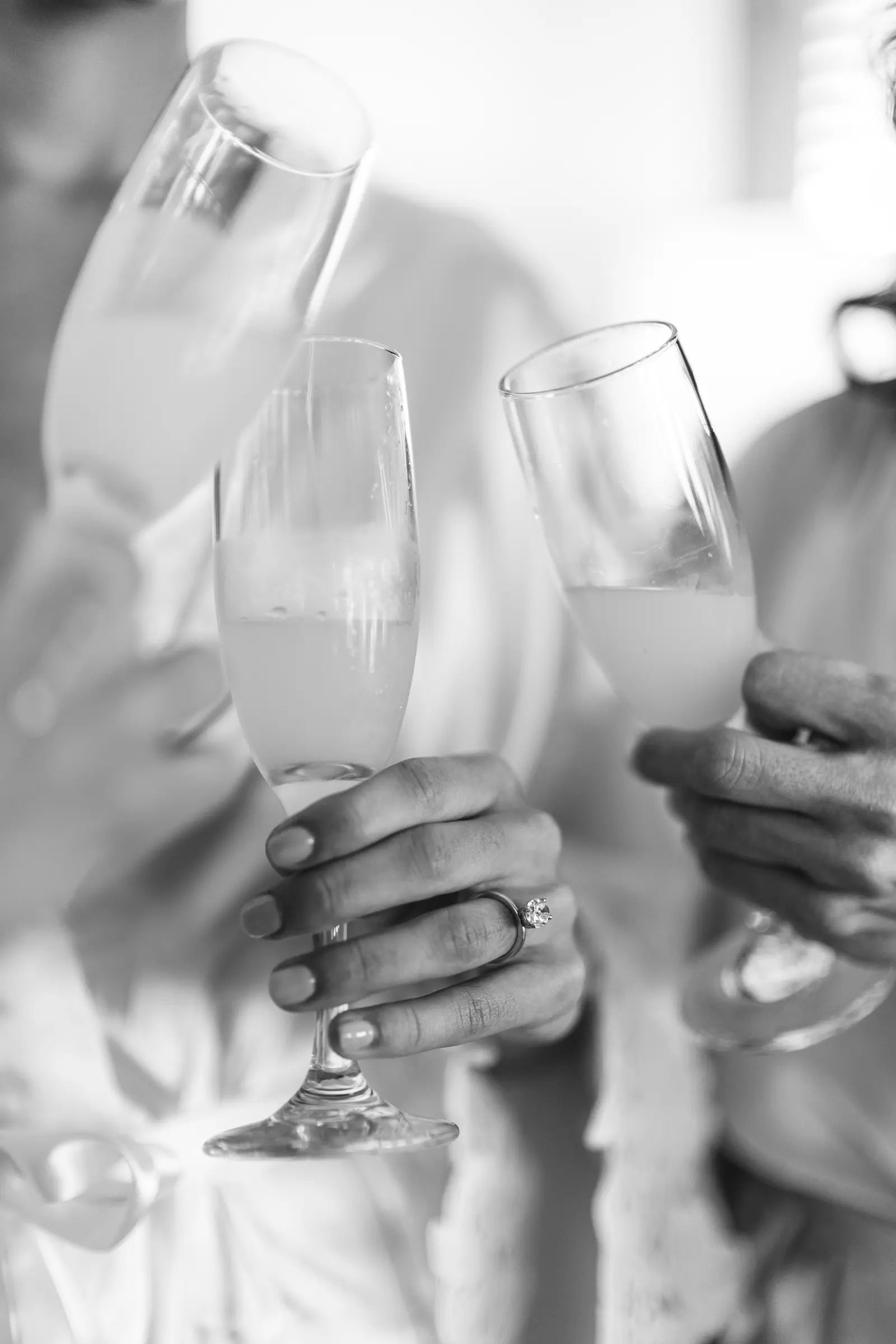 Close-up of hands holding champagne glasses