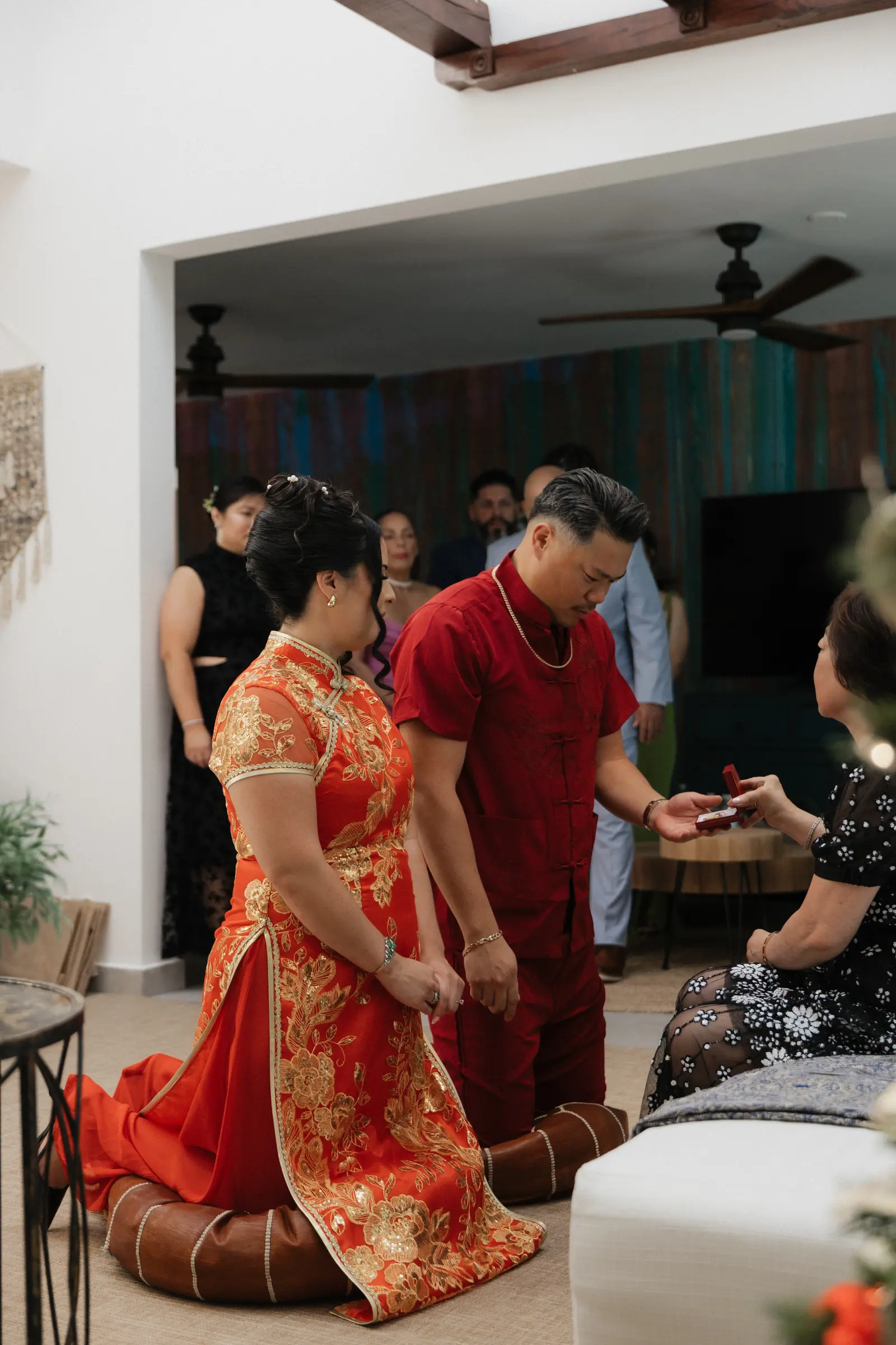 Family member blessing the bride in traditional attire during the ceremony