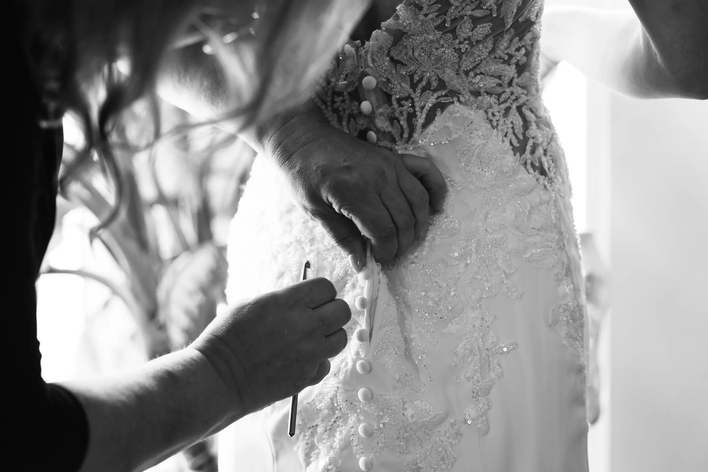 Close-up of hands adjusting the wedding dress