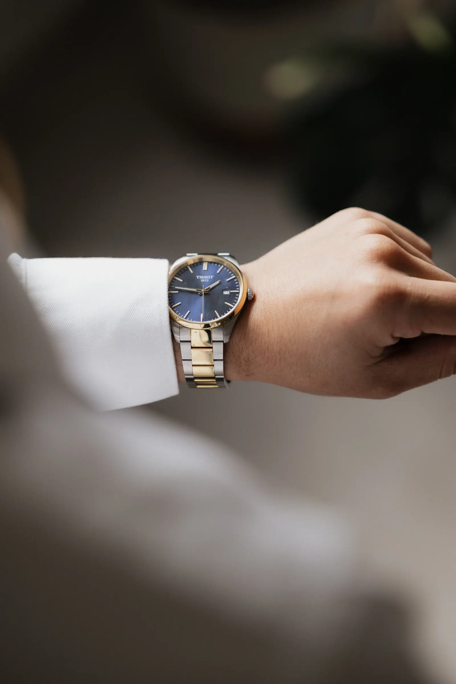 Close-up of the groom adjusting his wristwatch