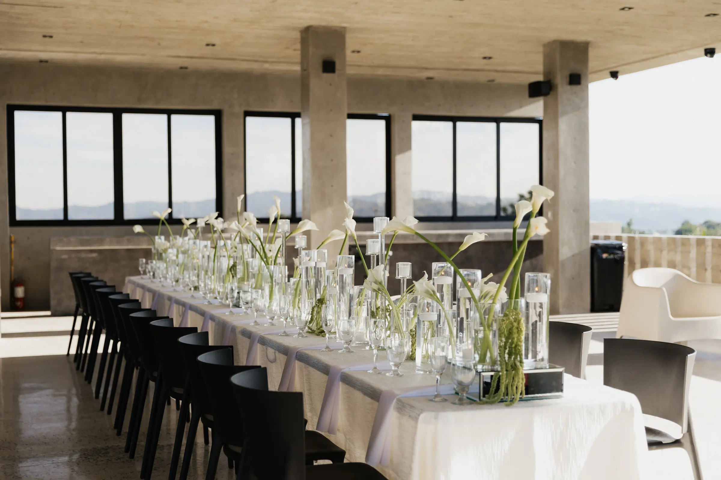 Reception table set for a long dinner overlooking the view