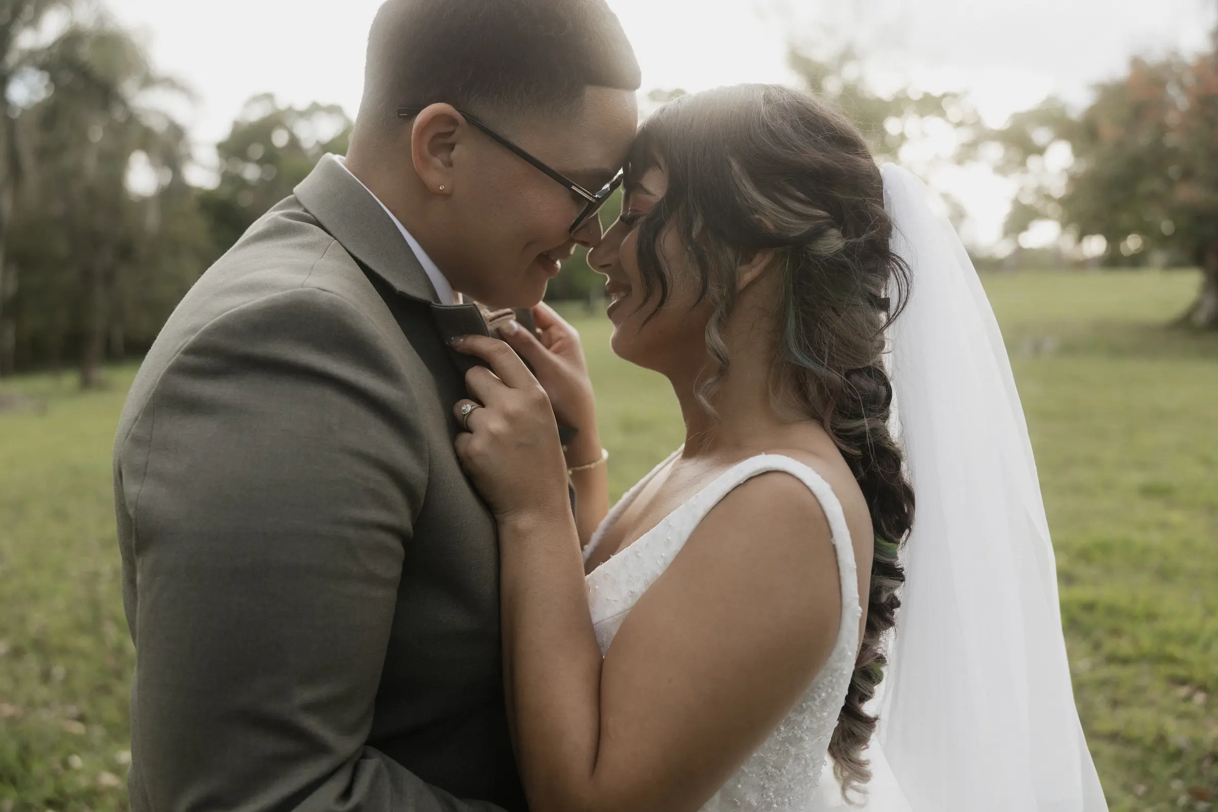 Bride and groom sharing a close moment outdoors