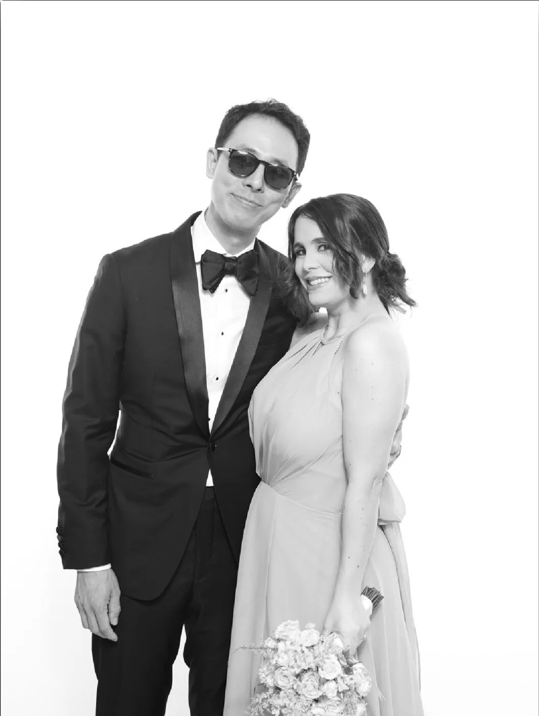 Wedding guests in black-tie attire posing for a black and white Bright Studio portrait