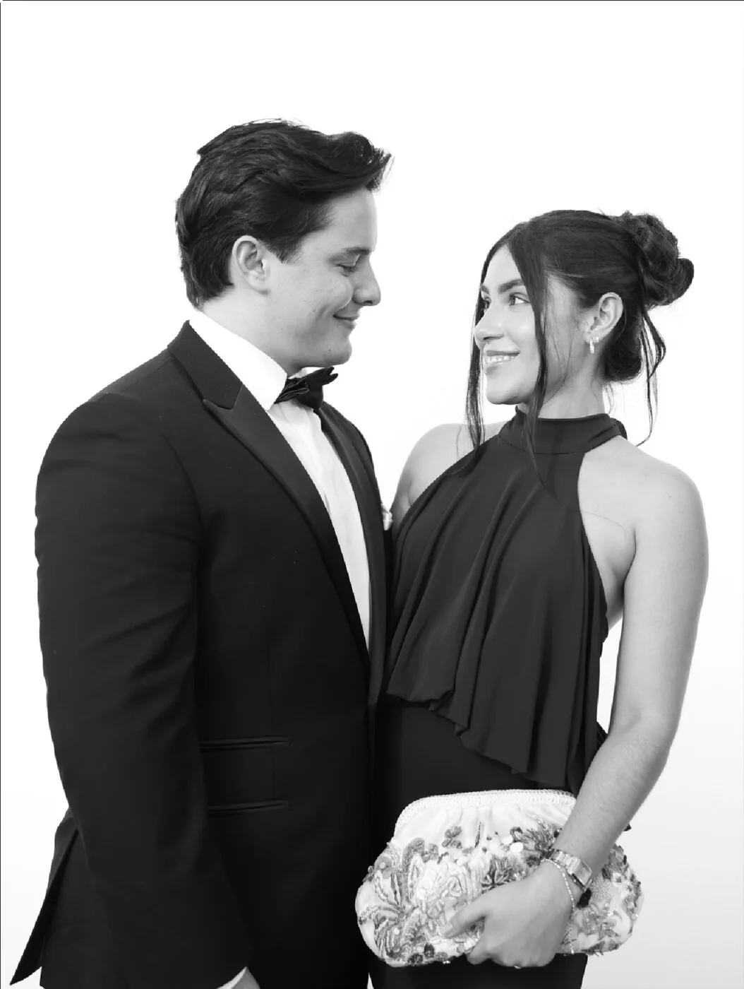 Two wedding guests smiling at each other in a black and white Bright Studio gala portrait
