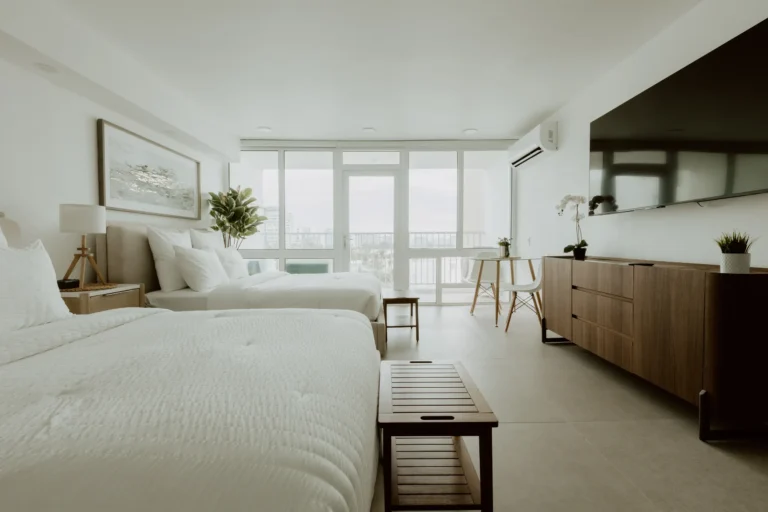 Bright open-concept bedroom and living space with large windows